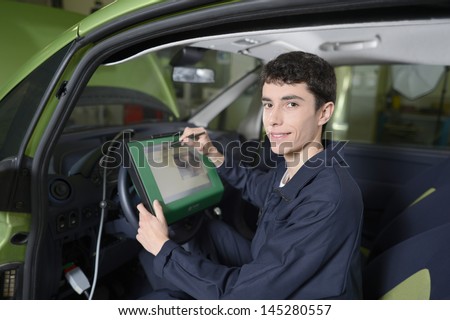 Students doing car diagnostic with computer