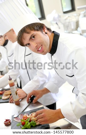 Smiling young man in restaurant kitchen