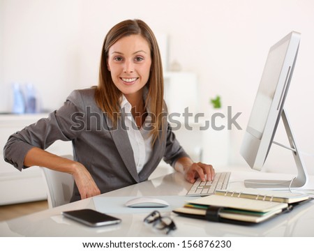 Saleswoman in office working on desktop computer