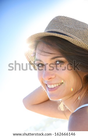 Portrait of beautiful woman with hat, light effect