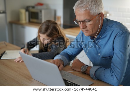 Similar – Image, Stock Photo Dad working on laptop with child sitting on his lap