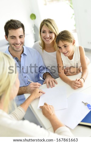Family signing contract with home seller