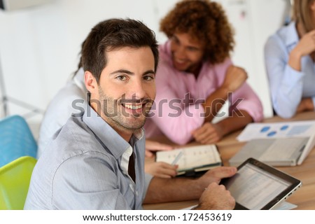 Smiling businessman attending business meeting