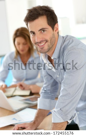 Smiling businessman attending work meeting