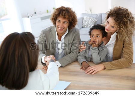 Family meeting real-estate agent for home purchase