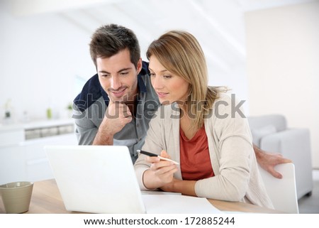 Couple at home working on laptop computer