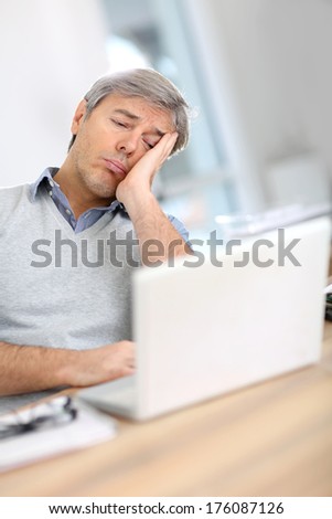 Businessman with worried expression while reading email
