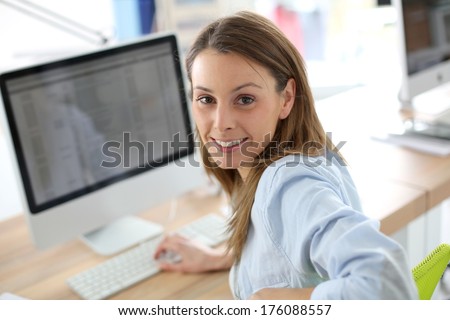 Portrait of woman in office in front of desktop