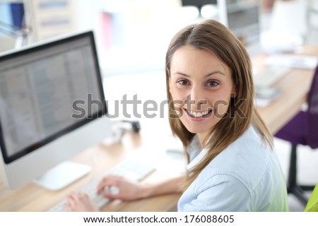 Portrait of woman in office in front of desktop