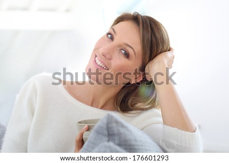 Portrait of middle-aged woman relaxing at home