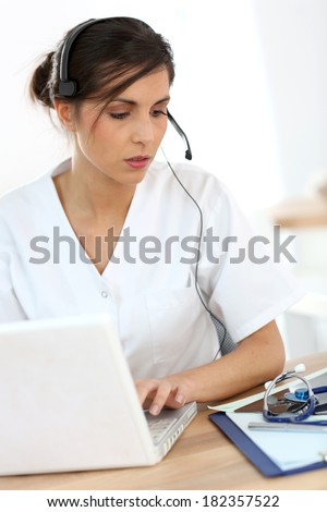 Portrait of medical secretary typing report
