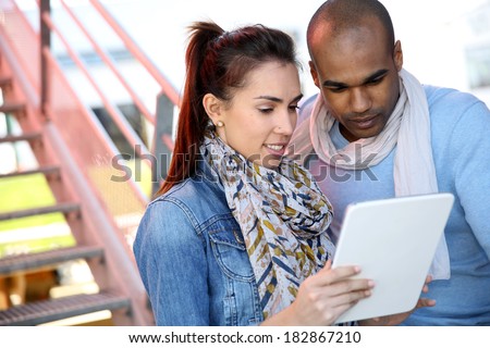 College people connected on internet with tablet