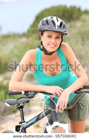 Portrait of smiling girl riding sports bike