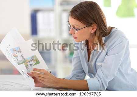 Woman architect working in office on project
