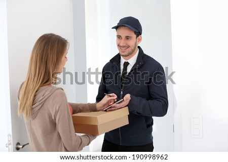Woman signing receipt of package delivery