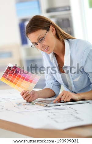 Woman architect working in office on project