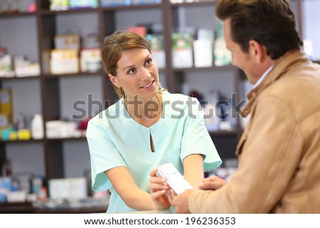 Pharmacist giving advice to customer on medication