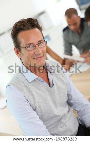 Mature businessman attending work meeting