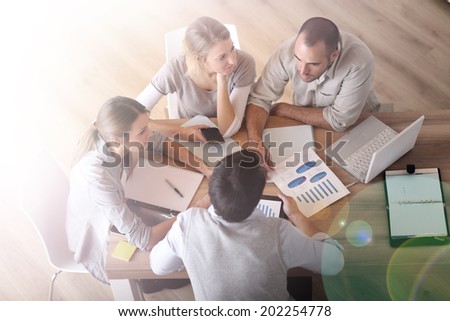 Upper view of business people around table