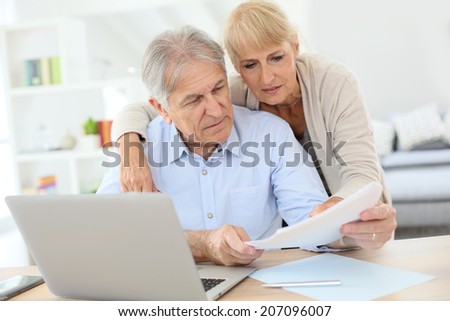 Senior couple doing the income tax declaration online