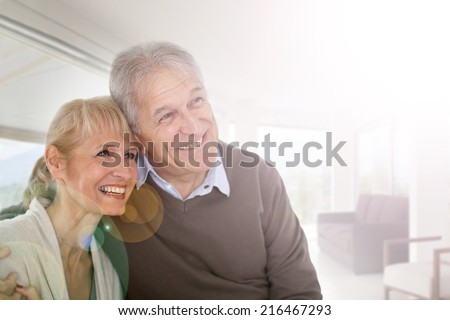 Senior couple looking on one side, being happy