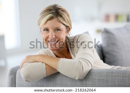 Beautiful 40-year-old woman relaxing in sofa