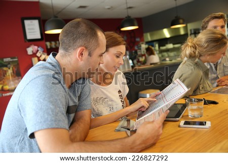 Students at lunch time choosing dish from menu
