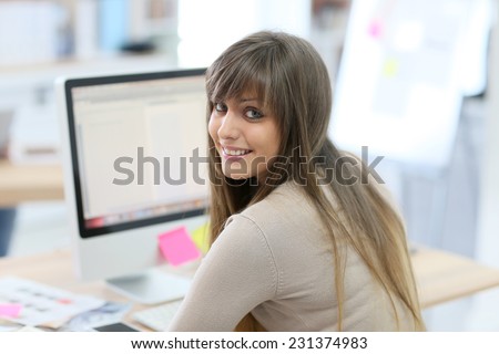 Student girl sitting in front of desktop computer