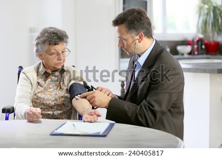 Doctor visiting elderly woman at home