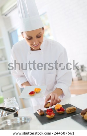 Pastry-cook preparing plate of cake bites
