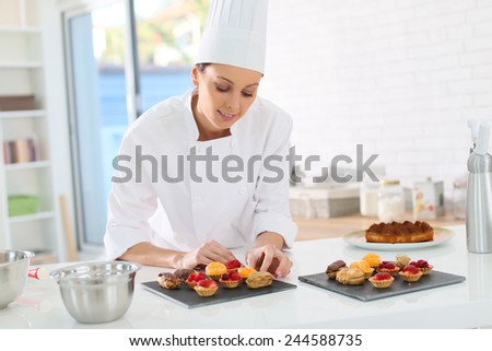 Pastry-cook preparing plate of cake bites