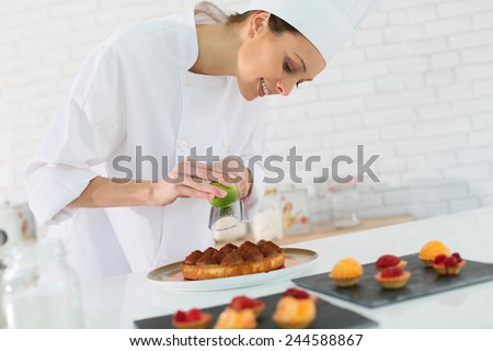Pastry-cook shreding lemon zest over cake bites