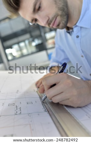 Architect designing on drafting table