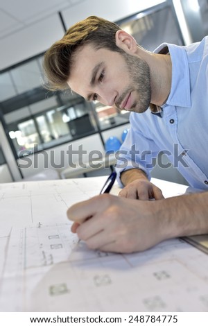Architect designing on drafting table