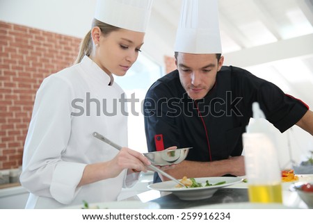 Girl in cooking training class with chef