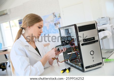 Student girl in technology fixug computer hard drive