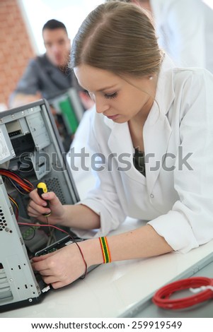 Student girl in technology fixing computer hard drive