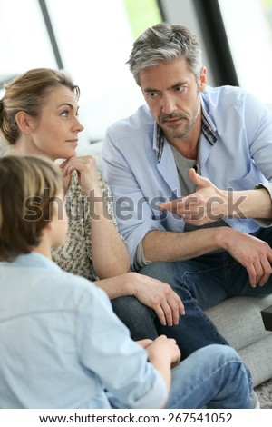 Parents having a talk with teenage boy