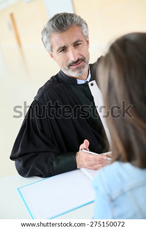 Lawyer meeting client in courthouse before trial