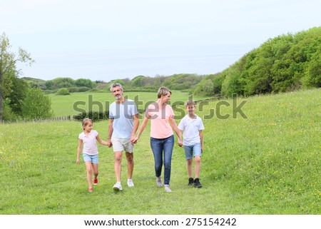 Family walking on country trail during vacation time