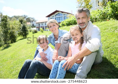 Happy family sitting in home private garden