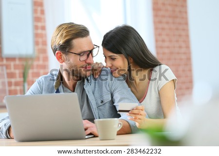 Couple at home shopping on internet