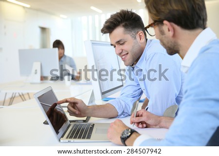 Businessmen in work meeting with laptop computer
