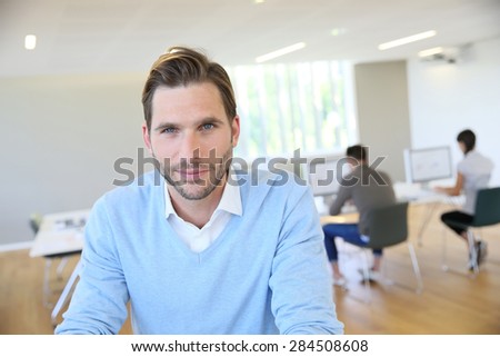 Portrait of middle-aged man with blue shirt in office