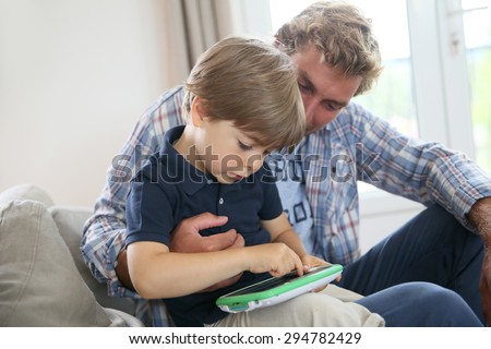 Daddy with kid playing with video game player