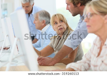 Group of senior people attending computing class