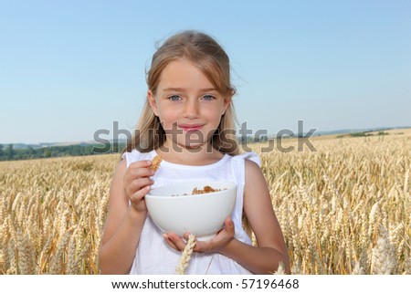 Closeup of little girl holding bowl of cereals
