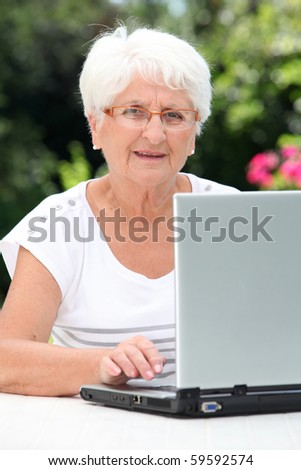 Closeup of elderly woman with laptop computer