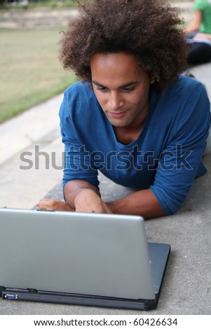 Student with laptop computer in college park