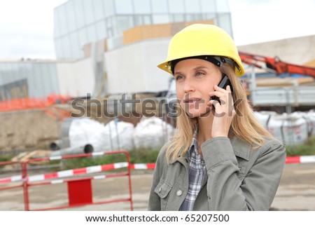 Architect on construction site with security helmet